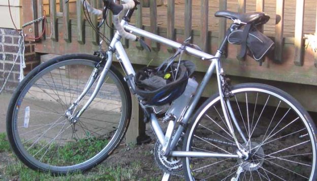 photo of road bike leaning against a deck