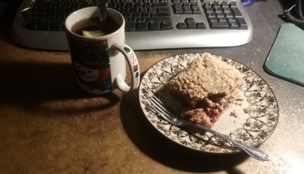 photo of cup of tea and slice of raspberry crumb cake